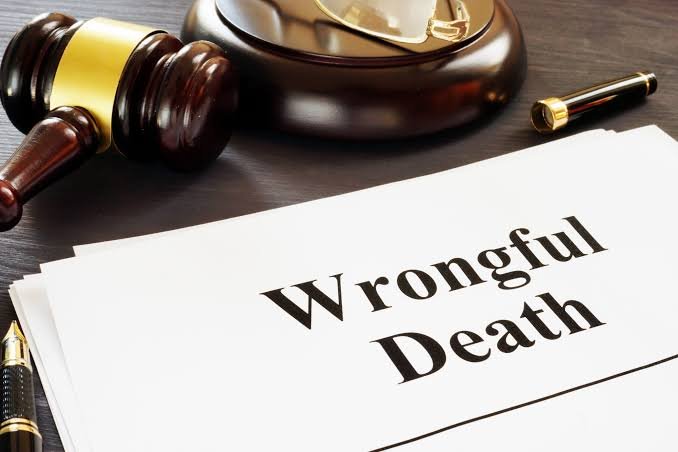 Legal documents printed with "Wrongful Death" rest on a dark desk beside a wooden gavel and fountain pen, highlighting legal representation from a Wrongful Death Claims Lawyer.